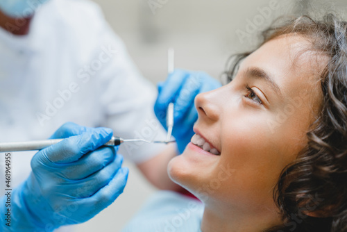 Side view portrait of a perfect ideal dreamy smile. Preteen caucasian boy visiting dentist orthodontist  doing doctor s teeth tooth mouth cavity checkup in clinic