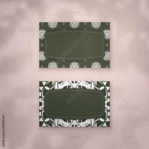 Fotografija A presentable business card in dark green with a luxurious white pattern for your contacts