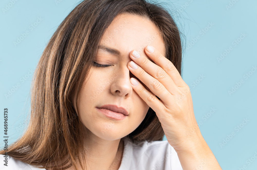 Young woman with headache touches her head eyes closed. Young woman with headache touches her head eyes closed.