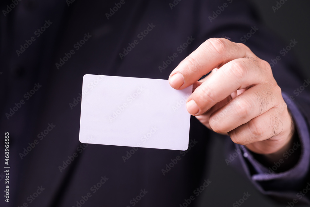 Closeup businessman show the empty white card in front of him Closeup businessman show the empty white card in front of him