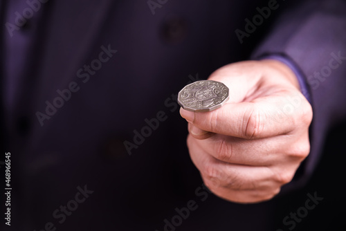 Businessman going to toss a coin photo