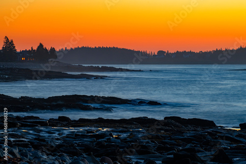 landscape of rocky beach coast under dawn twilight