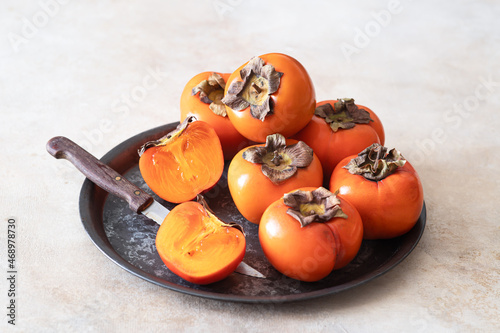 Ripe persimmon on light table	