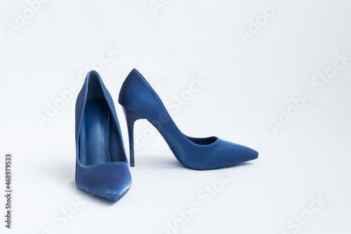 A pair of blue high-heeled shoes. Suede women's elegant shoes on a white background. Beautiful high and feminine heel