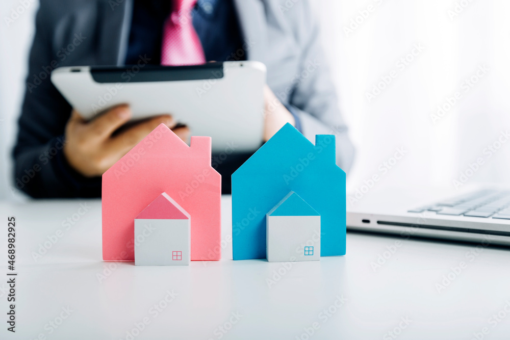 Model house and architectural project: real estate, relocation and home purchase concept Model house and architectural project: real estate, relocation and home purchase concept