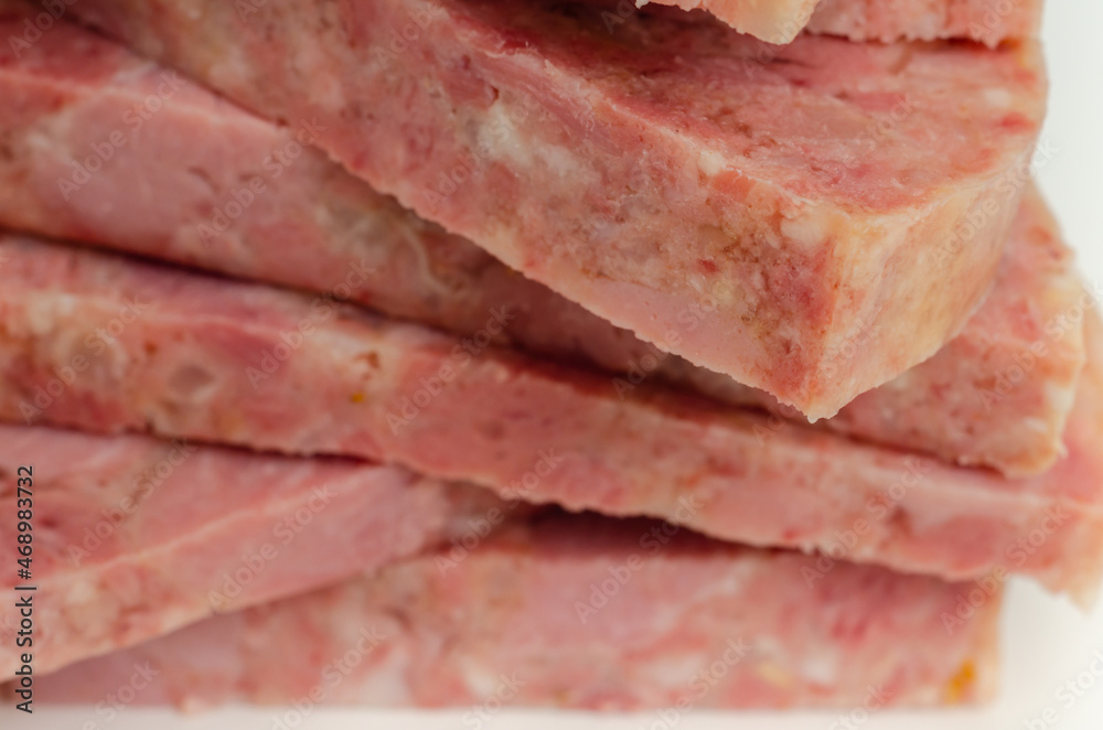 Thick slices of delicious brawn, cold cut made with flesh from the head of a pig in aspic Thick slices of delicious brawn, cold cut made with flesh from the head of a pig in aspic