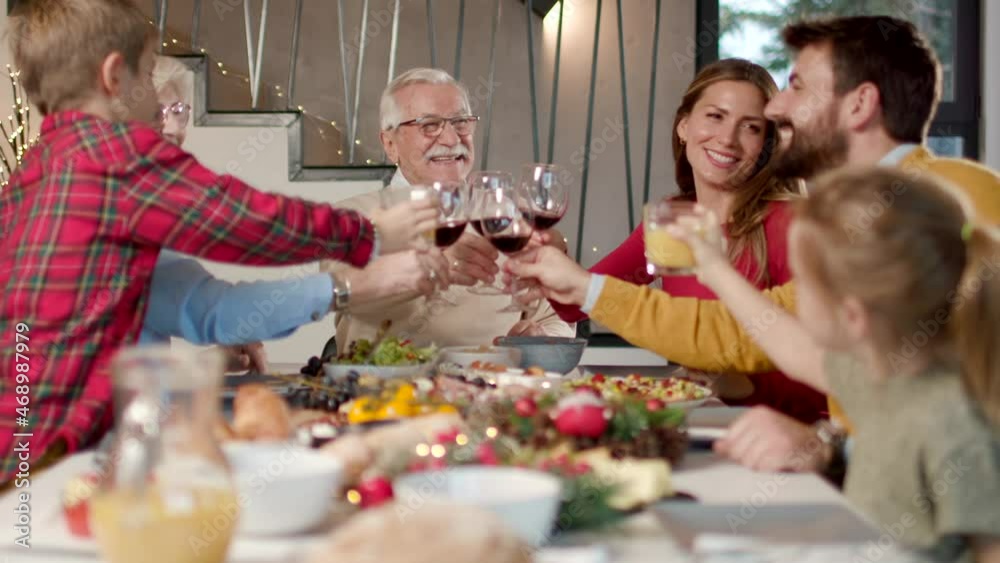 Happy family having a dinner with red wine at home