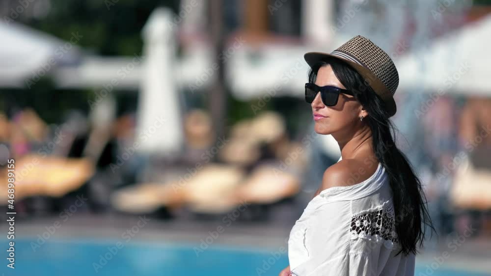 Pretty European brunette woman with tanned skin relaxing waterfall swimming pool spa resort Pretty European brunette woman with tanned skin relaxing waterfall swimming pool spa resort