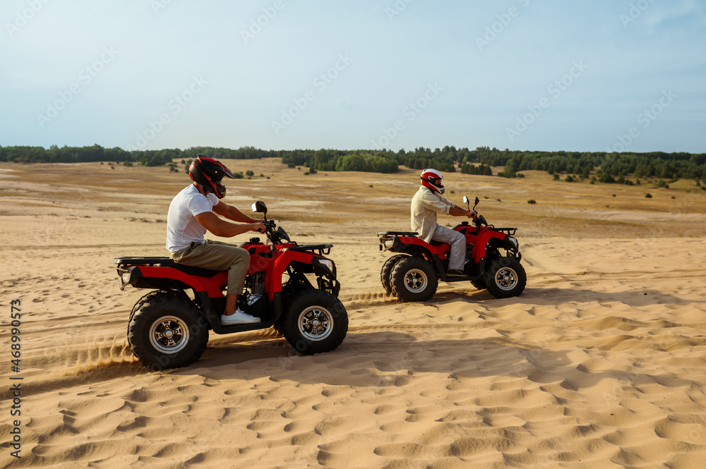 View on atv wheel, man in helmet on background