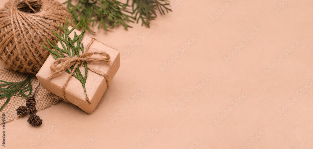Festive decoration of gifts in eco-style.Gift boxes are wrapped in craft paper,tied with cotton thread,decorated with thuja leave,cones and burlap.Christmas,New Year and eco-friendly concept,copyspace