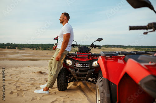 Wallpaper Mural Brutal man poses near atv in desert, quadbike Torontodigital.ca