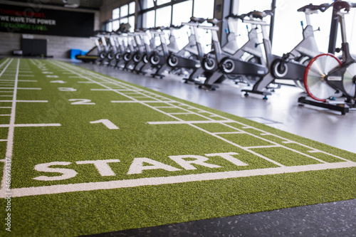 Artificial grass in the sport hall with the gym in background photo