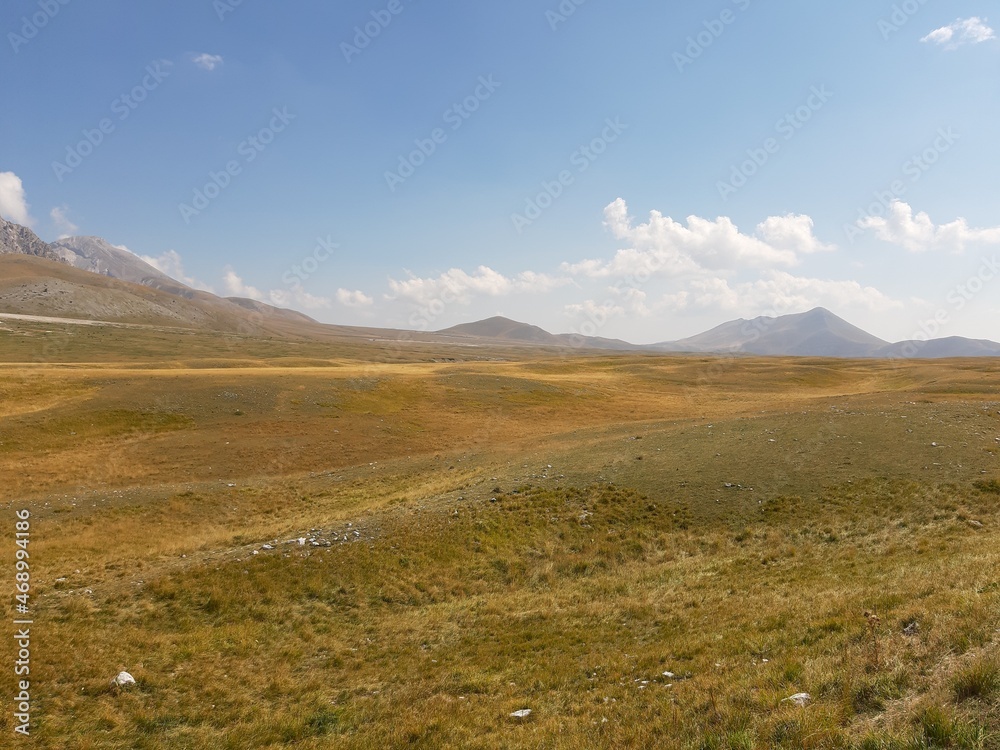 panorama of the prairie with in the background the mountains of Gran Sasso in Campo Imperatore Abruzzo called the little Tibet panorama of the prairie with in the background the mountains of Gran Sasso in Campo Imperatore Abruzzo called the little Tibet
