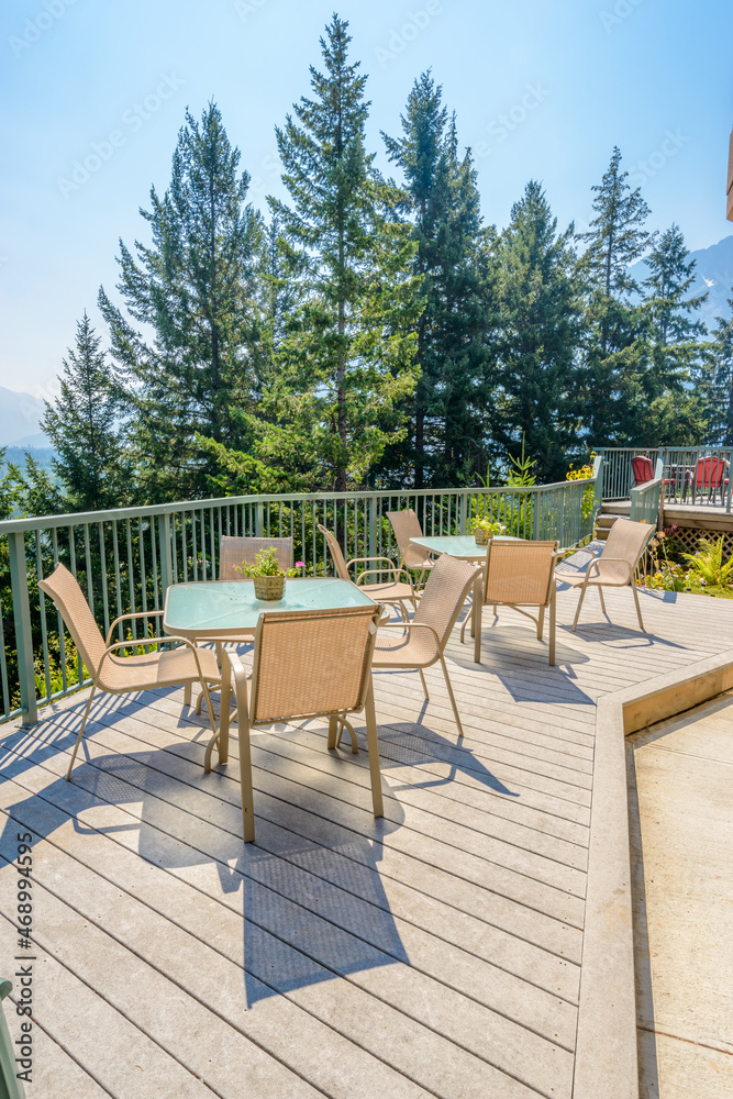 View of a stylish outdoor wooden floor patio with fantastic forest view. View of a stylish outdoor wooden floor patio with fantastic forest view.