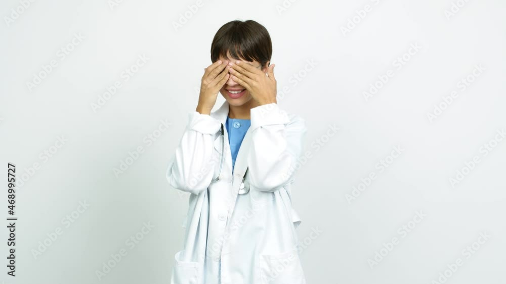 Young woman with nurse uniform covering eyes by hands. Surprised to see what is ahead over isolated background Young woman with nurse uniform covering eyes by hands. Surprised to see what is ahead over isolated background