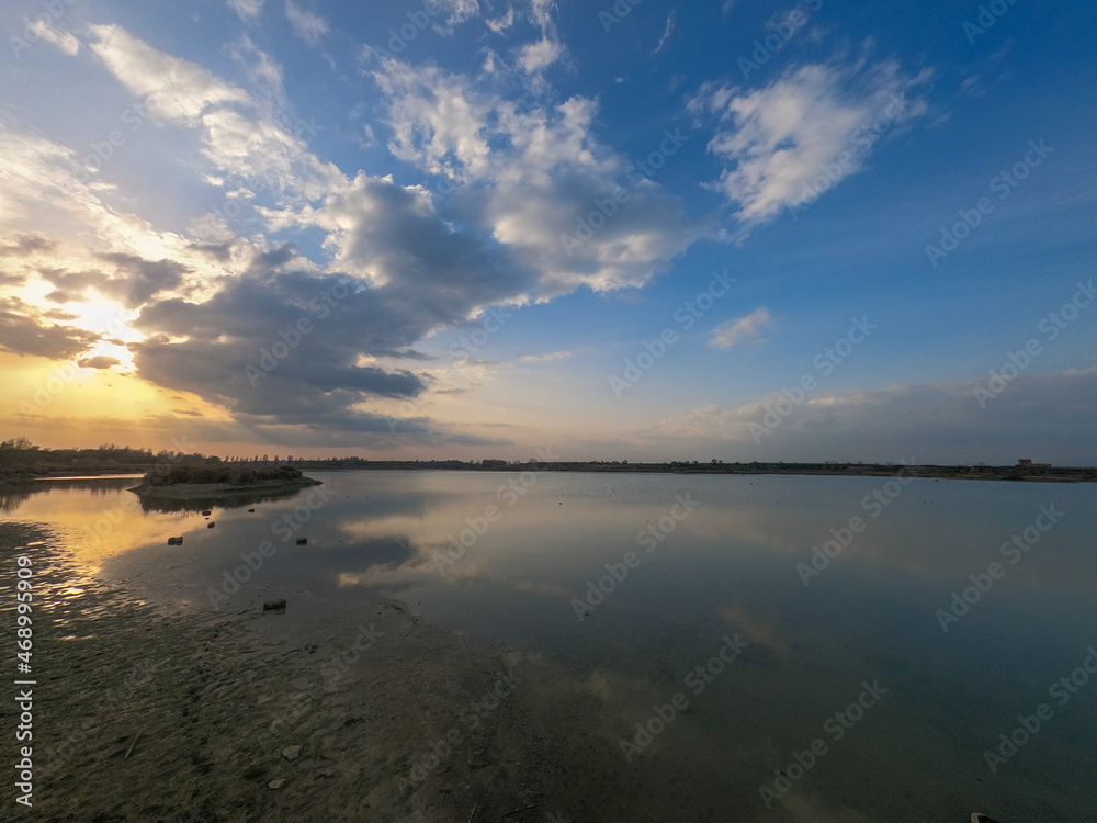 sunset at coast of the lake. Sunset sky. Smooth water sunset at coast of the lake. Sunset sky. Smooth water
