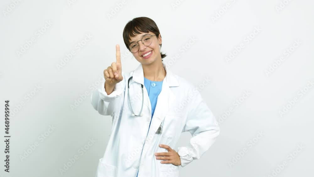 Young woman with nurse uniform showing and lifting a finger in sign of the best over isolated background Young woman with nurse uniform showing and lifting a finger in sign of the best over isolated background