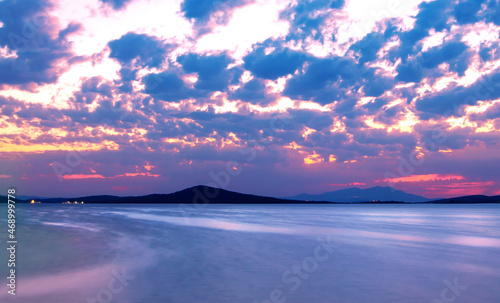 Long exposure photo of seascape and cloudscape from Ayvalik coastline after sunset. 