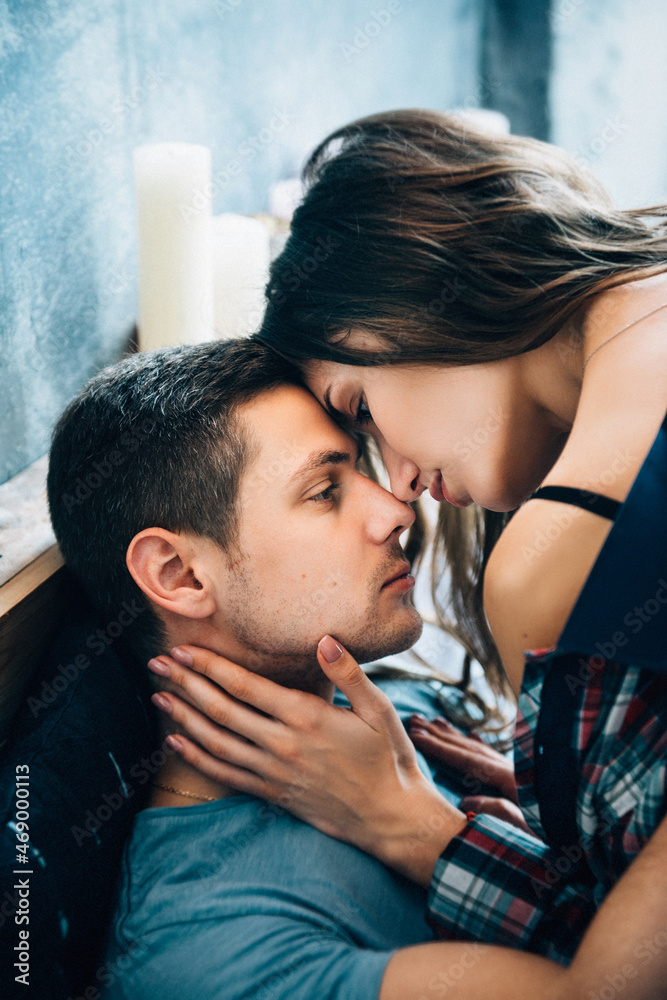 a guy and a girl lie on the bed in the room a guy and a girl lie on the bed in the room