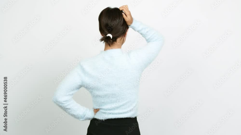 Young woman on back position looking back while scratching head over isolated background Young woman on back position looking back while scratching head over isolated background
