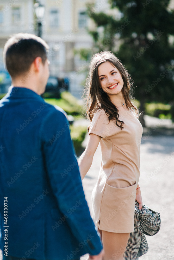 Fototapeta premium guy and a girl happily walk in the morning on the empty streets