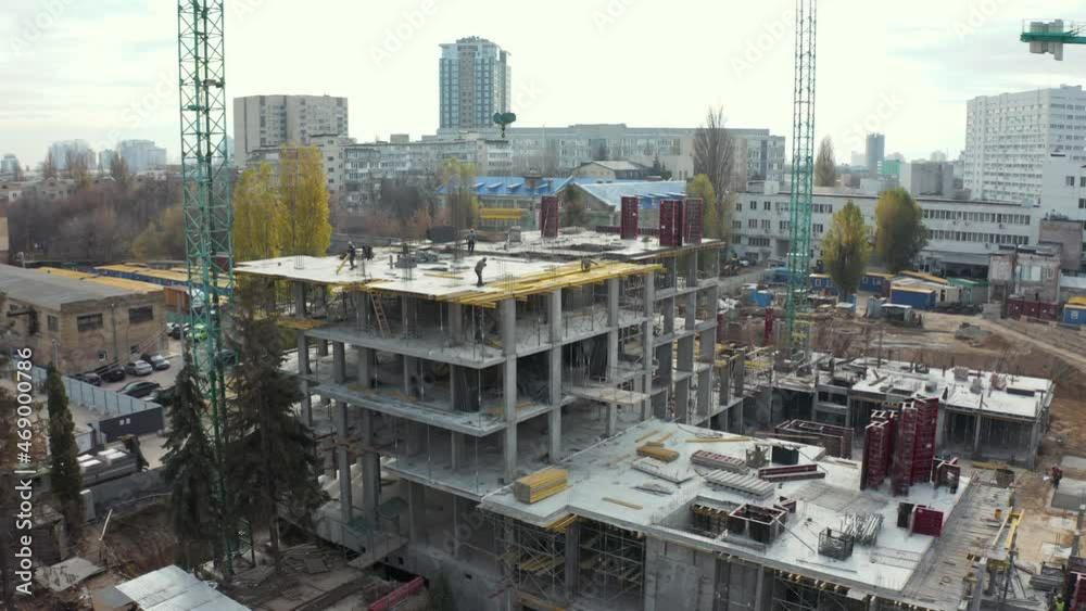 High crane works on building site with a house. Urban Construction Site, Aerial View. Construction area, building area, site area from above. New appartments getting built High crane works on building site with a house. Urban Construction Site, Aerial View. Construction area, building area, site area from above. New appartments getting built
