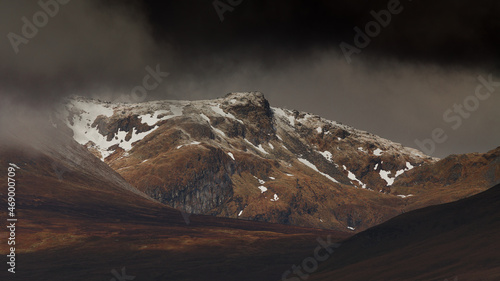 First snow on the slopes of Ben Lawers in cloudy weather. photo
