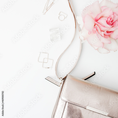 Minimal style. Minimalist Fashion photography. Decorative flat lay composition with cosmetics, women's accessories and flowers. Flat lay, top view on white background