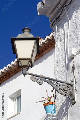 Frigiliana village southern Spain.  Beautiful Spanish mountain town typical of Andalusia.   Close up view of a traditional street lamp.  Vertical shot with copy space. photo