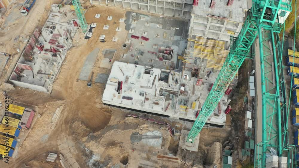 High crane works on building site with a house. Urban Construction Site, Aerial View. Construction area, building area, site area from above. New appartments getting built High crane works on building site with a house. Urban Construction Site, Aerial View. Construction area, building area, site area from above. New appartments getting built