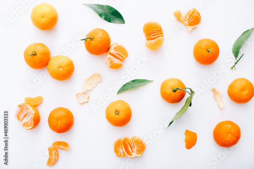 Fresh clementines with leaves on white background, top view