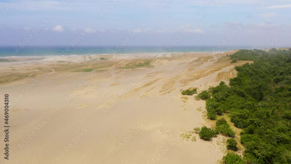 Sand dunes near the ocean, aerial view. Sand hills and trees. Summer and travel vacation concept. Landscape with sand hills. Sand dunes near the ocean, aerial view. Sand hills and trees. Summer and travel vacation concept. Landscape with sand hills.