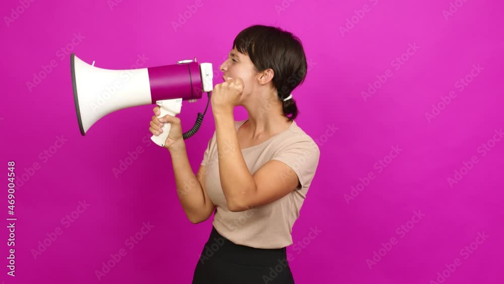 Young woman holding a megaphone and shouting over isolated background Young woman holding a megaphone and shouting over isolated background