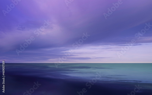 Dramatic cloudscape with purple, pink, and blue storm clouds gathering over the blue seawater.