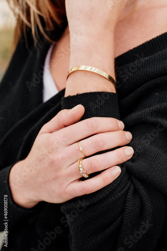 detail of rings on the hand of a Caucasian woman. model posing with jewelry.