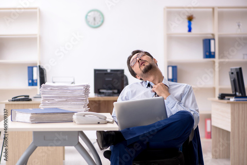 Young male employee working in the office