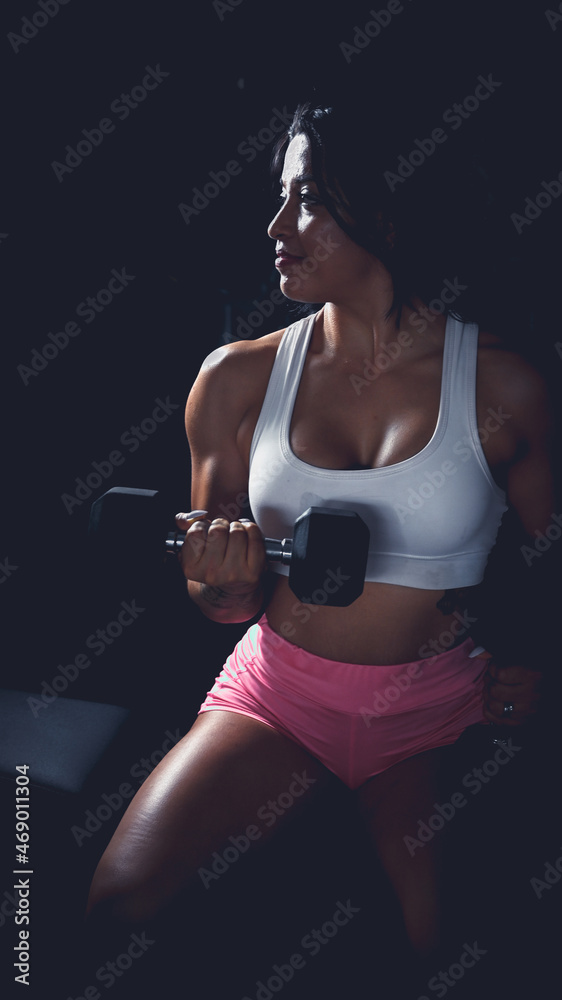 Cross training. Young woman exercising at the gym