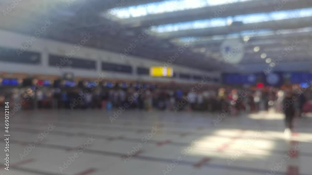 Huge queue inside the airport, passengers in masks stand in line for checking passports during pandemic. Blurred defocused video stock of passengers check in at the check-in counter at the Huge queue inside the airport, passengers in masks stand in line for checking passports during pandemic. Blurred defocused video stock of passengers check in at the check-in counter at the