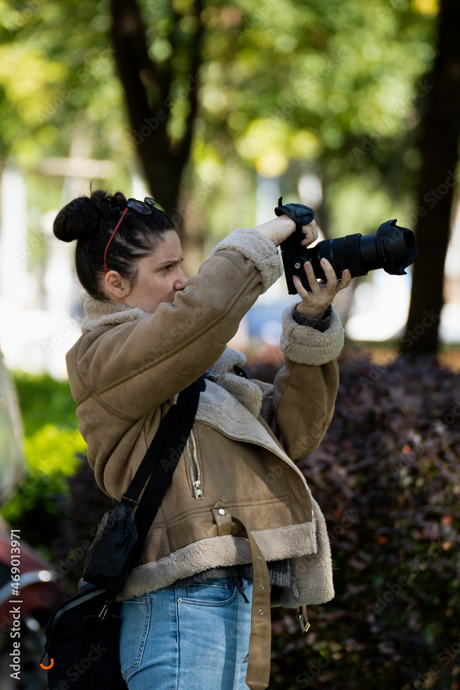 A female photographer taking a photo A female photographer taking a photo