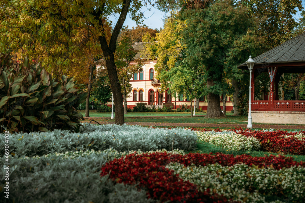 Amazing colorful garden in Palic with old historical building in the background