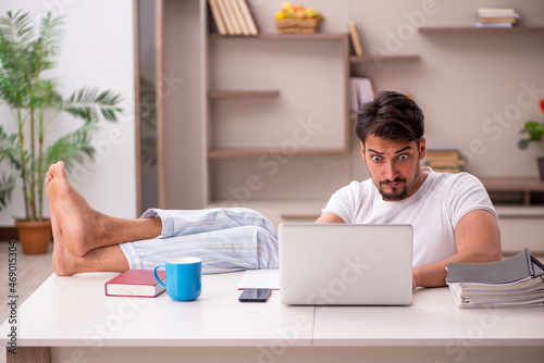 Young male employee working from home during pandemic