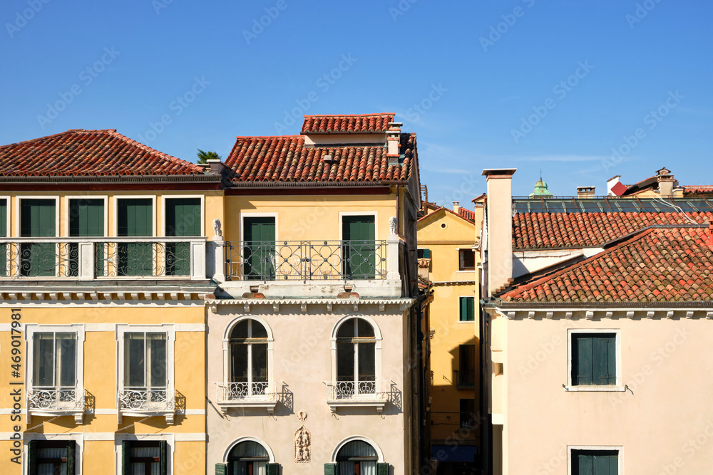Old houses in Venice, Italy. Ancient historic architecture of central Venice on a bright day with blue sky.