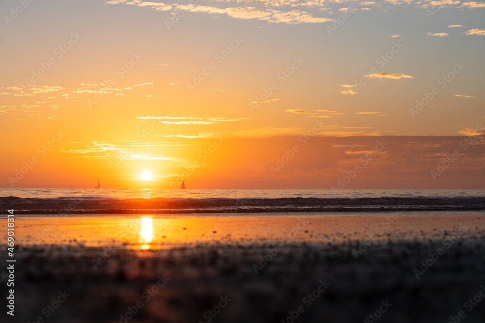 Fototapeta premium Sunset in the sea with beautiful clouds. Sunrise ocean seascape.