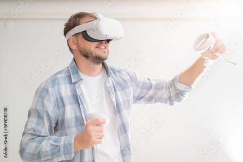man wearing Virtual Reality VR Headset. VR for gaming. Man play game in VR glasses. photo
