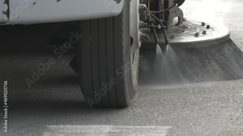 Closeup of a street sweeper approaching as it cleans the road photo