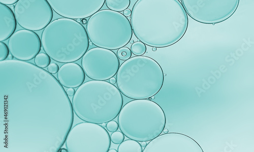 Oil and water bubbles on turquoise background.