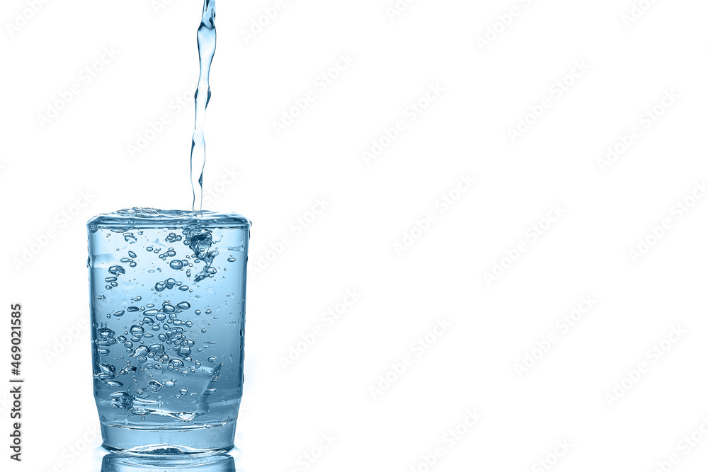 Water pouring over glass isolated on white background. Water pouring over glass isolated on white background.