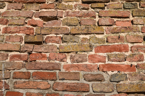 Colorful brick wall on the house. Texture of red stone blocks, close up. Background.