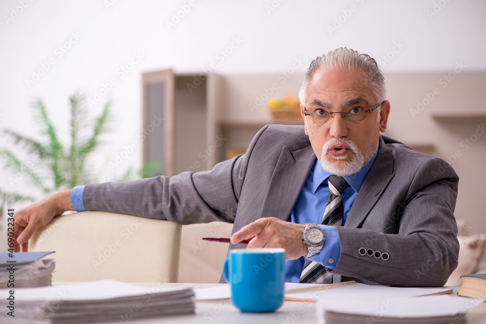 Old male employee working from home during pandemic Old male employee working from home during pandemic