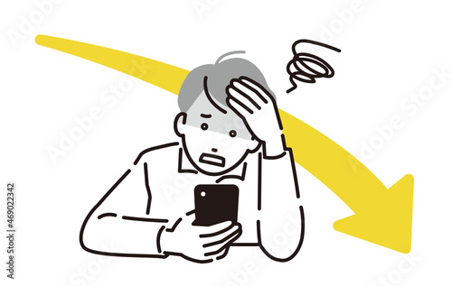 スマホを見て落ち込む男性